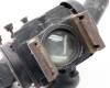 Close-up of condenser lens assembly with metal slide brackets and lens mount frame showing surface dust and wear