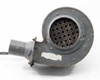 Torrington Electric blower — side view showing large round blower housing face with perforated inlet grille, white adhesive residue on housing, and tube outlet with flanged square mount at lower left