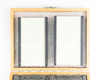 Top-down view of both Opt-Eng laser beam dump panels laid flat in open wooden case, showing white absorptive surfaces and numbered black frame rails
