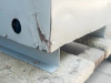 Jefferson Electric transformer – lower corner close-up showing impact damage with paint loss and rust at base corner near conduit knockout