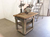 DeWalt 7790 radial arm saw full machine on stand with blade guard raised – warehouse floor view