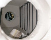 Interior tube furnace chamber view from opposite end showing heating element coils against ceramic refractory and center bore opening