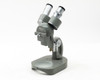 Elgeet No. 56896 stereo microscope full front-left three-quarter view showing binocular head, arm, and base