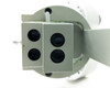 Bottom view of the dual objective turret showing all four objective lens apertures on the 2x/4x turret block