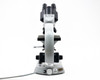 Carl Zeiss binocular microscope front view showing staff note label on head and asset tag N304 on base