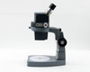 American Optical AO 569 Stereo Star Zoom Microscope right-side profile showing monocular eyepiece, zoom body, and 560-1 base