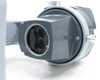 Bottom of AO 569 zoom head showing dual objective lenses from below, zoom body and arm visible