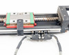 Hiwin KK60 linear stage mid-section showing ball screw with surface rust and limit switch sensor assembly