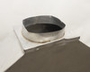 Top of fume hood showing 10-inch round exhaust collar with visible sealant residue around base and surface discoloration