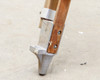 Aluminum foot detail on wooden leg — spike-style foot with bolted aluminum collar and lower leg section