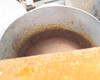 Close-up of conveyor drum end face showing stamped part numbers B7889-5 and C36302 with surface rust detail