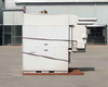 Capstone C65 microturbine generator – right side profile view on pallet showing louvered panels and external conduit runs