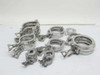 Lot of 21 Balzers Pall stainless ISA KF vacuum flange clamps in mixed sizes spread on white surface