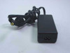 OEM SYS1102-2005 AC adapter – left-side view showing IEC C8 AC input socket, coiled DC output cable, and yellow-tipped barrel plug
