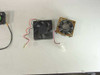 Two 12V cooling fans side by side — 60mm axial fan with 2-pin red/black leads and a gold-framed 50mm CPU fan with Molex connector