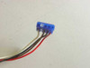 Close-up of a 4-pin blue fan connector with red, black, white, and yellow leads