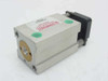Compact Air Products GC234X12 Guided Block Cylinder – rear end view showing gold-colored bore opening, black rear mounting block, green port plug, and Compact logo label with date code 8/96