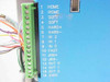 Anaheim Automation DPY65352 – closeup of 16-position green screw terminal block with I/O labels: HOME, SOFT, HARD+/-, IN 0-2, FAST, JOG+/-, OUT 0-2, 0VDC