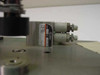 Close-up of SMC pneumatic cylinder with label showing 12–50 bar range and dual push-in fittings