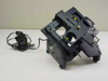 Custom optical stage assembly with four circular optical apertures and yellow LED lights — three-quarter front view with external power adapter