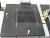 Pneumatic toggle clamp fixture assembly – top-down view of slotted vacuum chuck grid surface with locating pins and mounting hardware