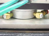 Mack Corp S1014-2 Bonder Assembly – detail of actuator puck with brass pneumatic fittings and green air lines attached