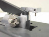 Close-up of wafer bonder lever clamp mechanism showing machined aluminum clamp block, pivot pin, and adjustment screw