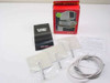 Qualtec 06127 Lok-Kit contents laid out next to box — three adhesive plates, security cable, PC Security Solutions catalog, and instruction sheet