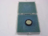 Ealing 35-3441 bandpass optical filter resting in open foam-lined Ealing plastic case — filter visible in lower foam recess