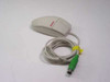 Compaq M-S34 PS/2 ball mouse right side and rear angle view showing cable routing and green PS/2 connector with yellow cable tie