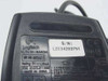 Dell Logitech M-SAW34 mouse — bottom label showing model M-SAW34, Logitech branding, FCC ID DZL211029, 5V 15mA rating, Made in China, and serial number sticker