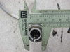 Male 4-pin circular connector held in Manostat calipers showing pin arrangement and connector body diameter