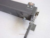 End view of optical apparatus linear rail showing chain drive mechanism and end bracket detail