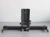 Custom optical apparatus with moveable lens housing on linear slide rail — front view showing full assembly