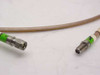 Close-up of SMA male connector (left) and SMA female connector (right) on Thermax RG400/U cable showing green strain-relief boots