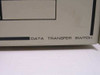 Close-up of data transfer switch front panel lower-right corner showing DATA TRANSFER SWITCH label