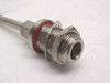 Close-up of N female bulkhead panel-mount connector end on semi-rigid coaxial cable, showing red O-ring seal and hex nut mounting hardware