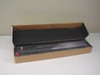 AMD AM27C2048 EPROM chips stored in anti-static rail tray inside open cardboard box — multiple units visible