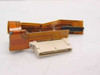 Apple 821-0056-A video harness flex cable adapter for PowerBook 520C — top view showing orange flex ribbon and white board connector