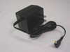 Sony AC-E455 AC power adapter – right-side view showing compact black body, folding US prongs, and output cable with barrel connector