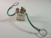 AT&T 62A/U Telephone Station Protector – top view showing white terminal block body with green grounding jumper wire and ring terminals