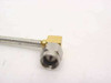 Close-up of right-angle SMA male connector end showing gold and stainless steel construction with 90-degree elbow body and hexagonal coupling nut