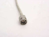 Close-up of straight SMA male connector end showing stainless steel hexagonal coupling nut and center pin on semi-rigid coaxial cable