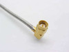 Close-up of right-angle angled SMA male connector end of semi-rigid coaxial cable showing gold-plated brass 90-degree connector