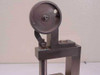 Close-up of the large wheel actuator and arm linkage assembly on the measurement fixture, side view