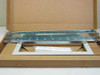HP J1469A rack mount kit showing metal slide rails and white bezel panel in open box