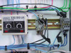 Omron S3S-B10-US Controller — close-up of second unit showing ON DELAY and OFF DELAY knobs and indicator lights, with Square D relay visible to right