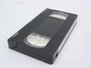 Maxell VHS tape cartridge out of case – top view showing tape reels