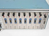 TCL 2110 rear card bay close-up showing eight installed module cards with blue DB-9 connectors and red/black indicator LEDs