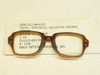 Halo Optical 6540-01-146-4272 brown cellulose acetate military spectacle front with DLA label card showing NSN, size 46 eye 20 bridge, and 1989 date code